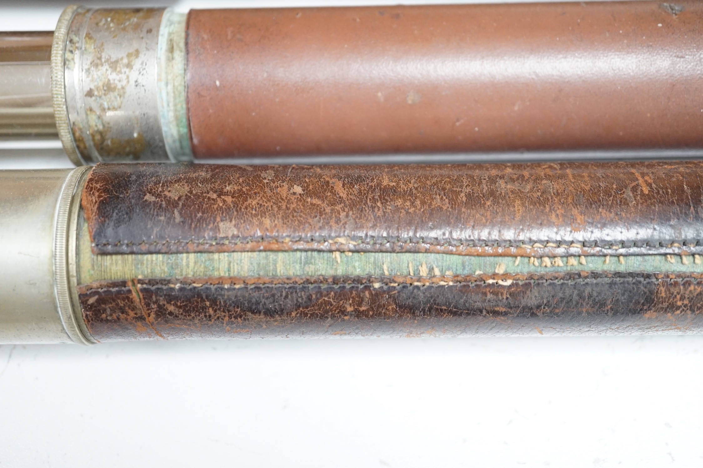 Three leather bound telescopes